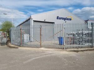 Commercial fencing surrounding a Euroglaze facility, showcasing security features and outdoor improvements.