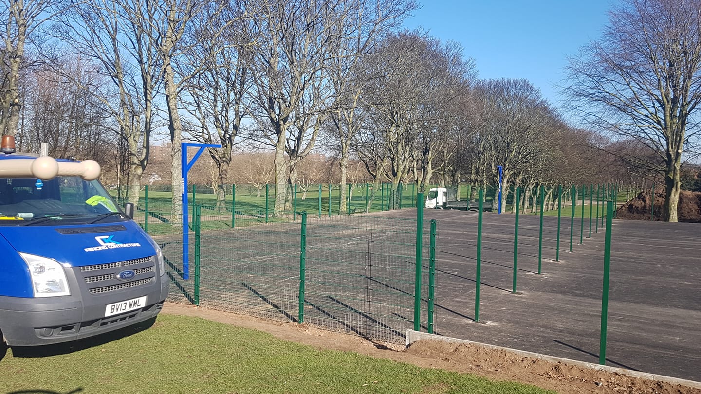 Fencing installation for multi-use games area (MUGA) with heavy-gauge metal posts and green mesh, showcasing CK Fencing Contractors' durable sports pitch solutions.