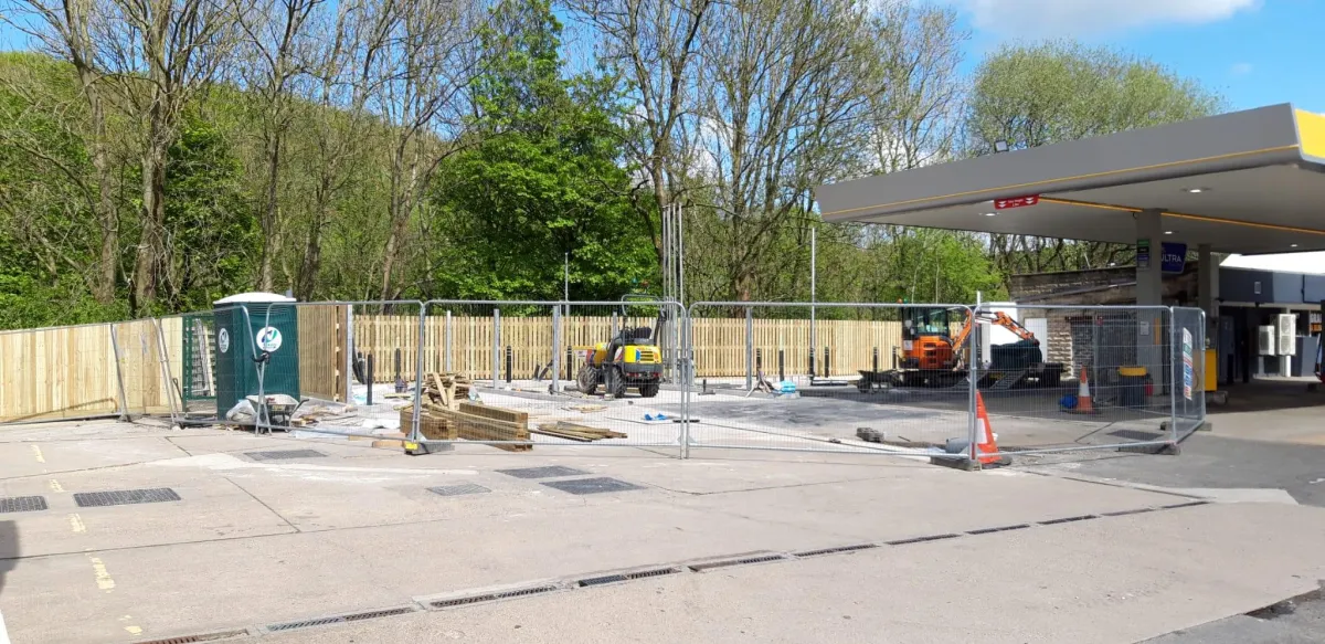 Construction site at JET Fuel Station in Sheffield, featuring fencing, machinery, and materials for site preparation.