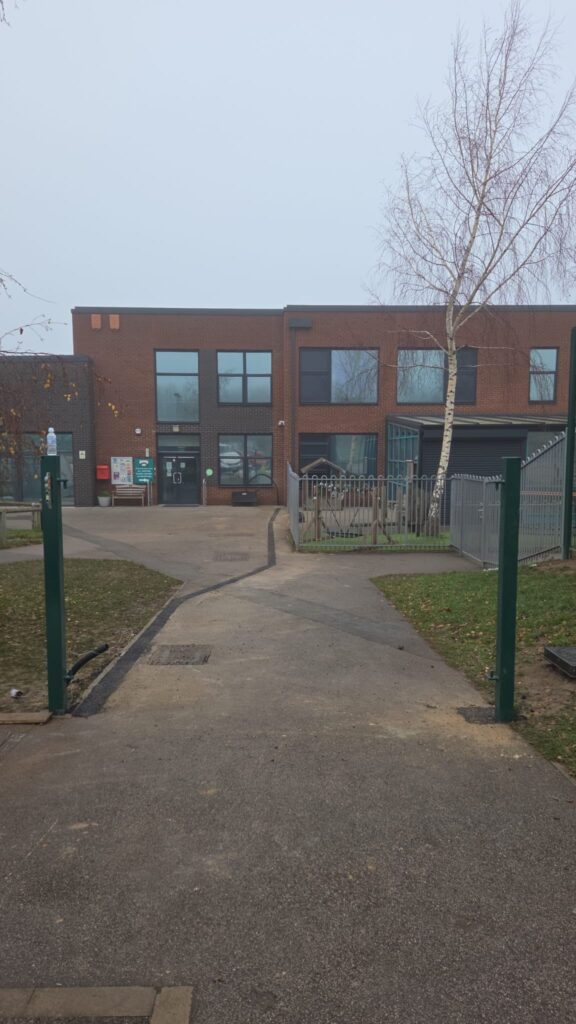Entrance to Faurburn View Primary School featuring twin mesh fencing, palisade gates, and a clear pathway leading to the school building.